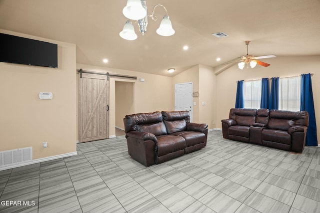 tiled living room with a barn door, ceiling fan with notable chandelier, and lofted ceiling