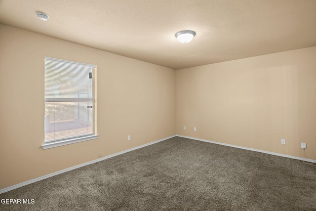 carpeted spare room with a textured ceiling