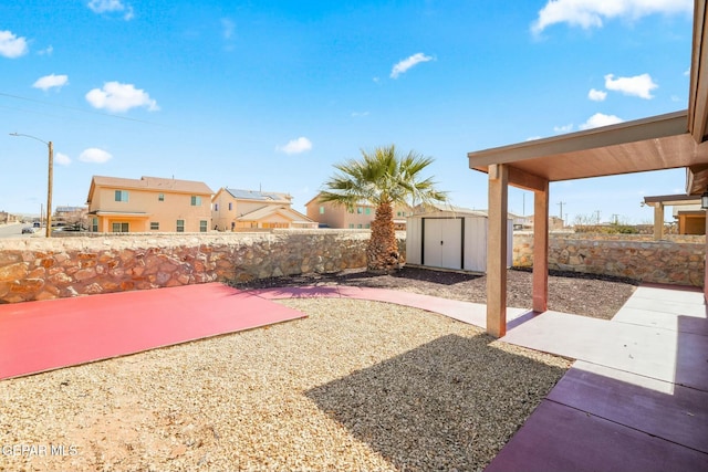 view of yard with a shed and a patio