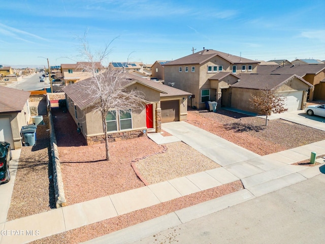 view of front of property featuring a garage and central AC unit