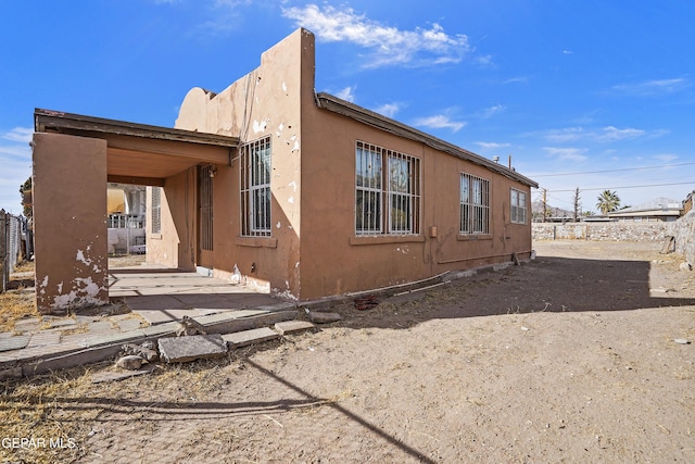 view of property exterior featuring a patio area