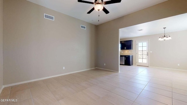 13749 Lorenz Ave, El Paso, TX 79928 - unfurnished living room with ceiling fan with notable chandelier and light tile patterned flooring