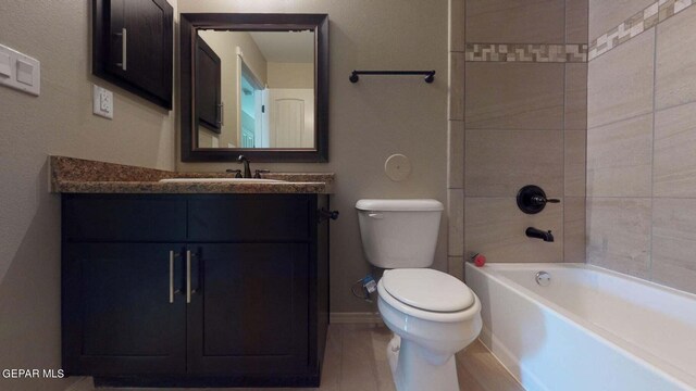 13749 Lorenz Ave, El Paso, TX 79928 - full bathroom featuring tiled shower / bath combo, vanity, and toilet
