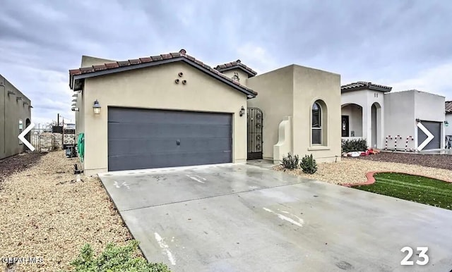 mediterranean / spanish home with a garage