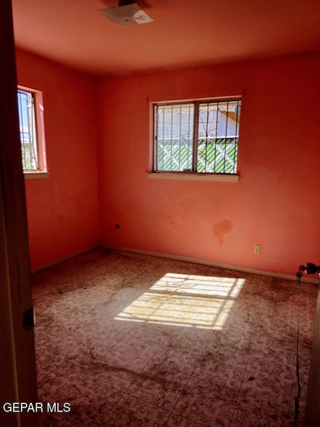 unfurnished room featuring a wealth of natural light