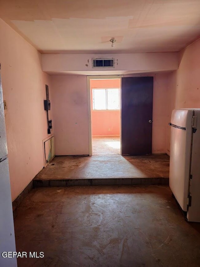 unfurnished room featuring concrete floors