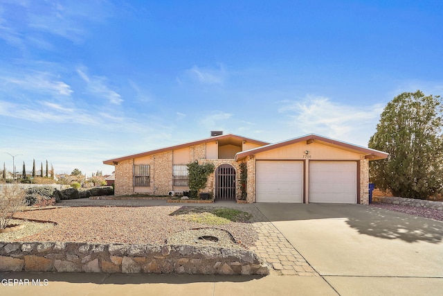 ranch-style home featuring a garage