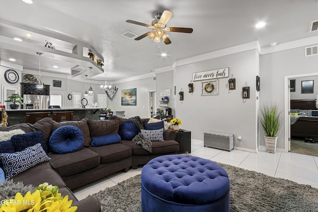 living room featuring light tile patterned floors, crown molding, and ceiling fan with notable chandelier