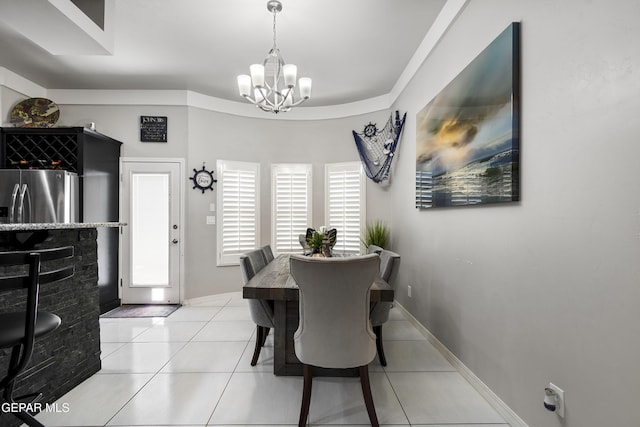 tiled dining space with an inviting chandelier