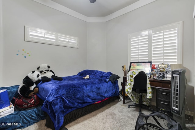 carpeted bedroom with ornamental molding