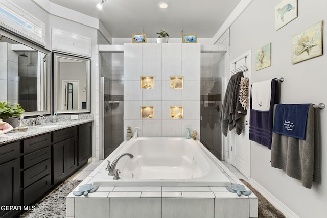 bathroom with vanity and separate shower and tub