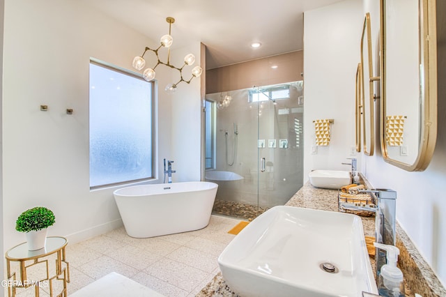 bathroom featuring vanity, plus walk in shower, and a chandelier