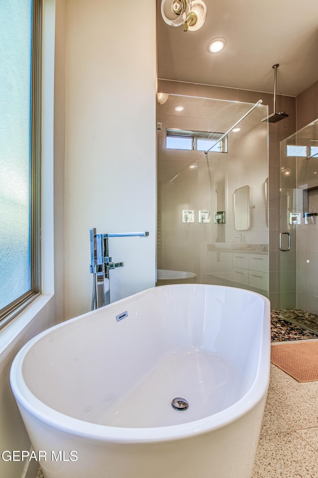 bathroom with plenty of natural light and independent shower and bath