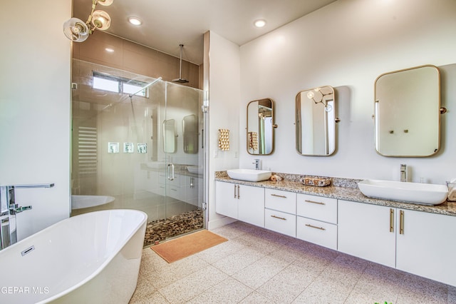 bathroom with vanity and independent shower and bath