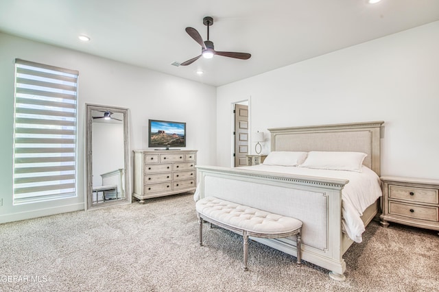 bedroom featuring light colored carpet and ceiling fan