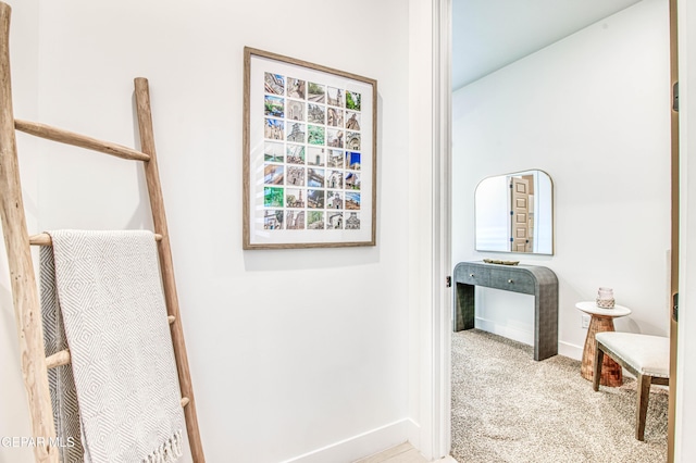 hallway with light colored carpet