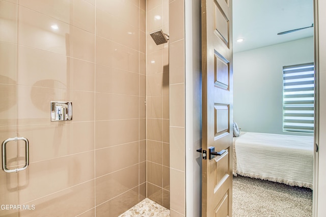 bathroom with a shower with door