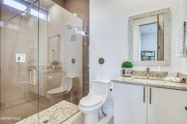 bathroom with vanity, toilet, and an enclosed shower