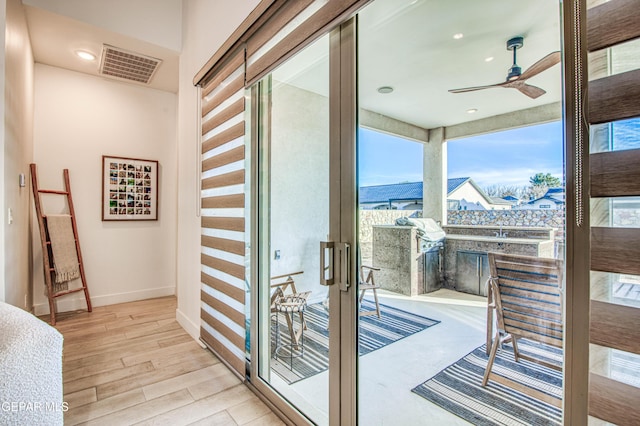 interior space with a bar, a mountain view, and ceiling fan