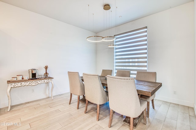 dining area featuring light wood-type flooring