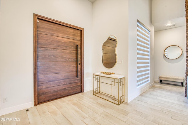 foyer entrance with light hardwood / wood-style flooring