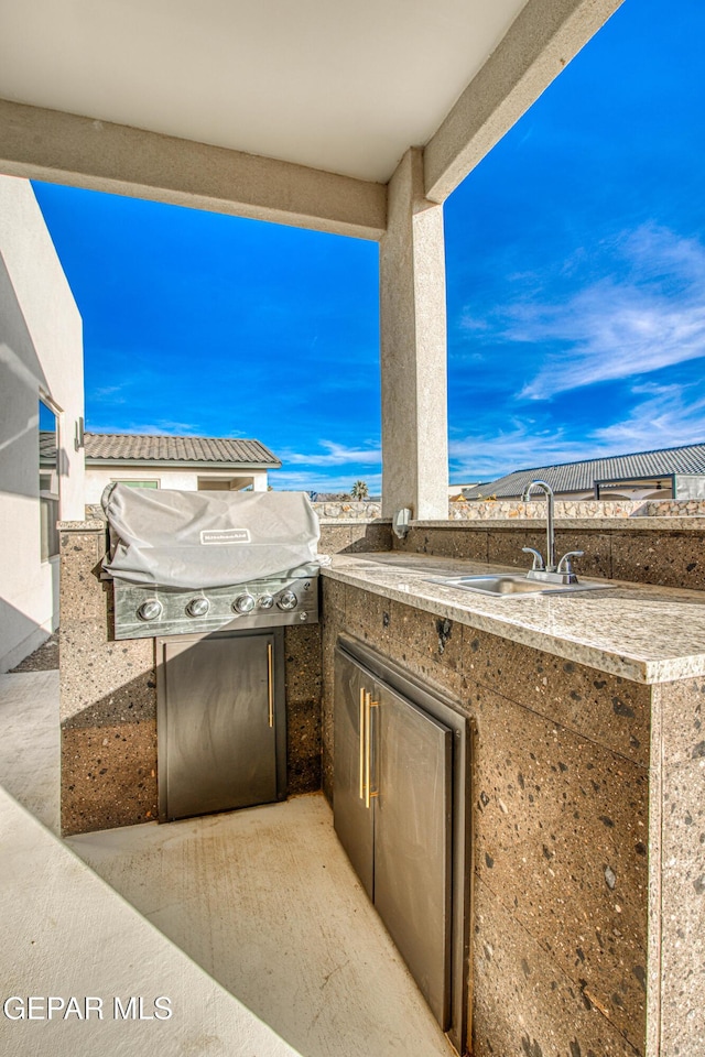 view of patio / terrace featuring area for grilling, sink, and grilling area