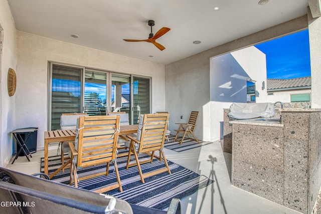 view of patio with area for grilling, ceiling fan, and an outdoor wet bar