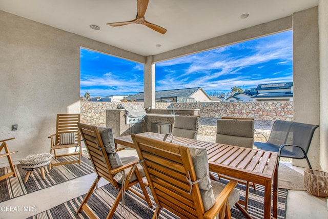 view of patio / terrace with ceiling fan and an outdoor kitchen