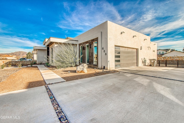 view of front of home with a mountain view and a garage