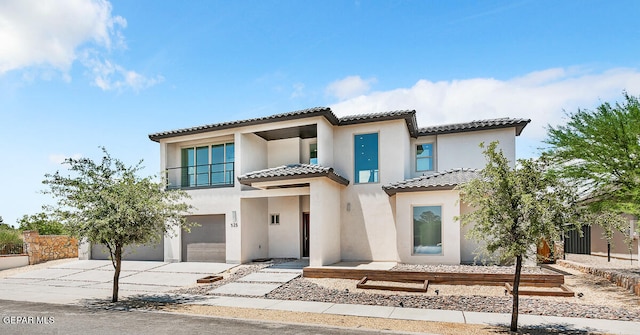 mediterranean / spanish home with a garage