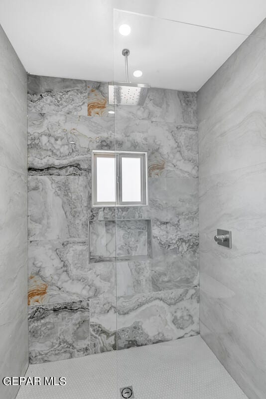 bathroom with a tile shower