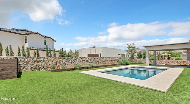 view of pool with a yard