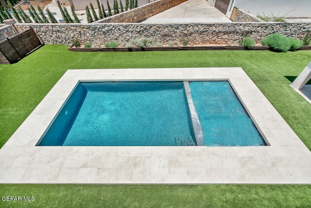 view of pool with a yard and a patio