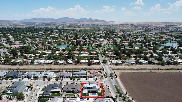 birds eye view of property with a water and mountain view