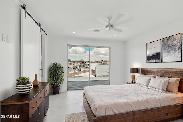 bedroom featuring access to exterior, a barn door, and ceiling fan