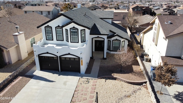 view of front of home with a garage and central AC