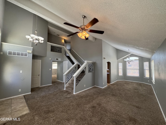 unfurnished living room with high vaulted ceiling, carpet flooring, ceiling fan with notable chandelier, and a textured ceiling