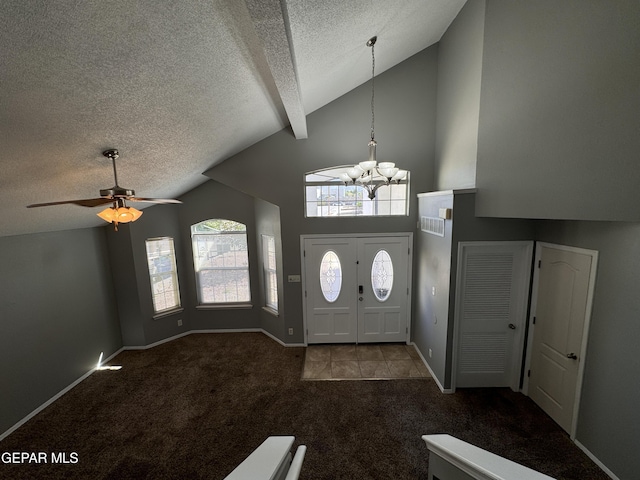 carpeted entrance foyer featuring lofted ceiling with beams, ceiling fan with notable chandelier, and a textured ceiling