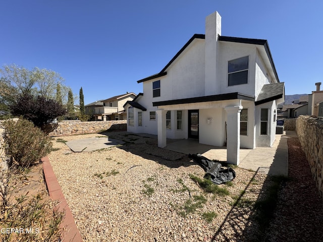 back of house with a patio