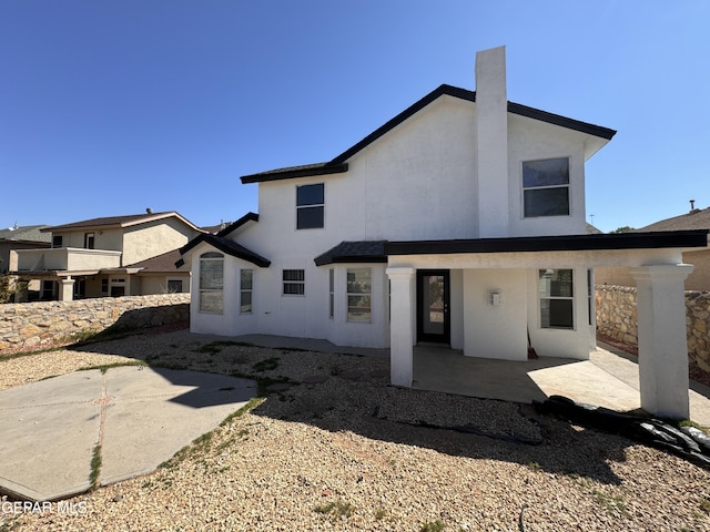 back of property with a patio