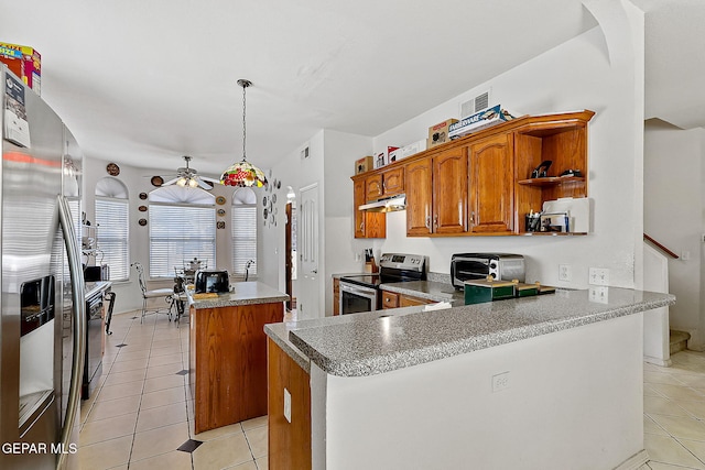 kitchen with hanging light fixtures, light tile patterned floors, stainless steel appliances, and a center island