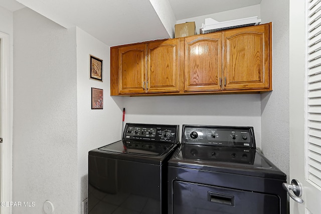 laundry area featuring cabinets and separate washer and dryer