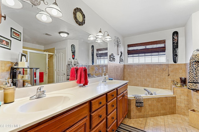 bathroom featuring vanity, tile patterned floors, plus walk in shower, and tile walls