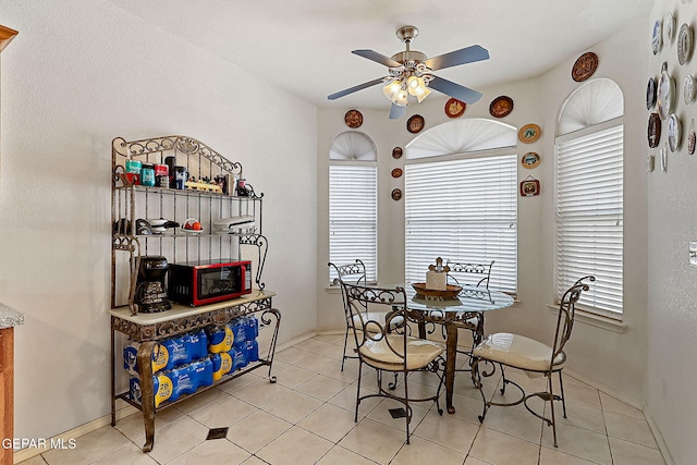 dining area featuring light tile patterned floors and ceiling fan