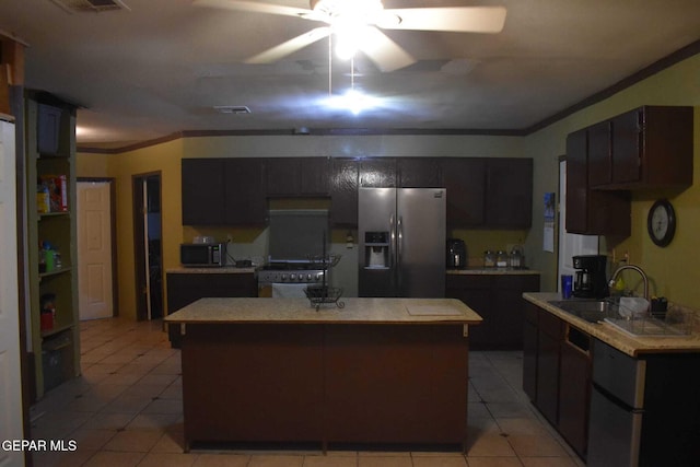 kitchen with appliances with stainless steel finishes, a center island, sink, and dark brown cabinets