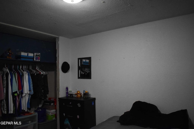 bedroom featuring a closet and a textured ceiling