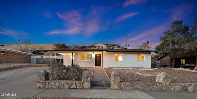 single story home featuring concrete driveway