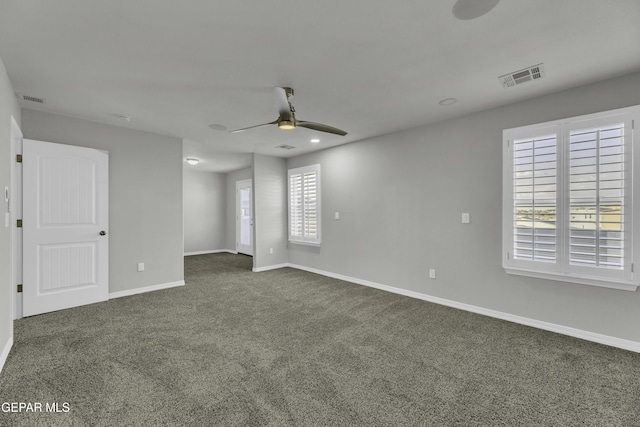 carpeted spare room with ceiling fan