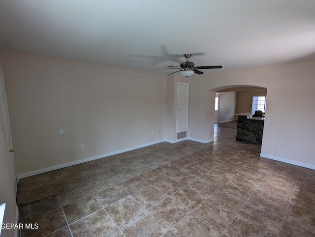 unfurnished living room with ceiling fan