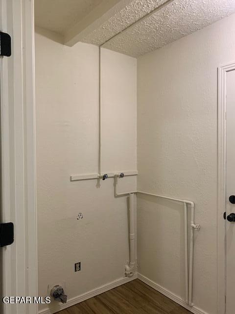 laundry room featuring dark wood-type flooring